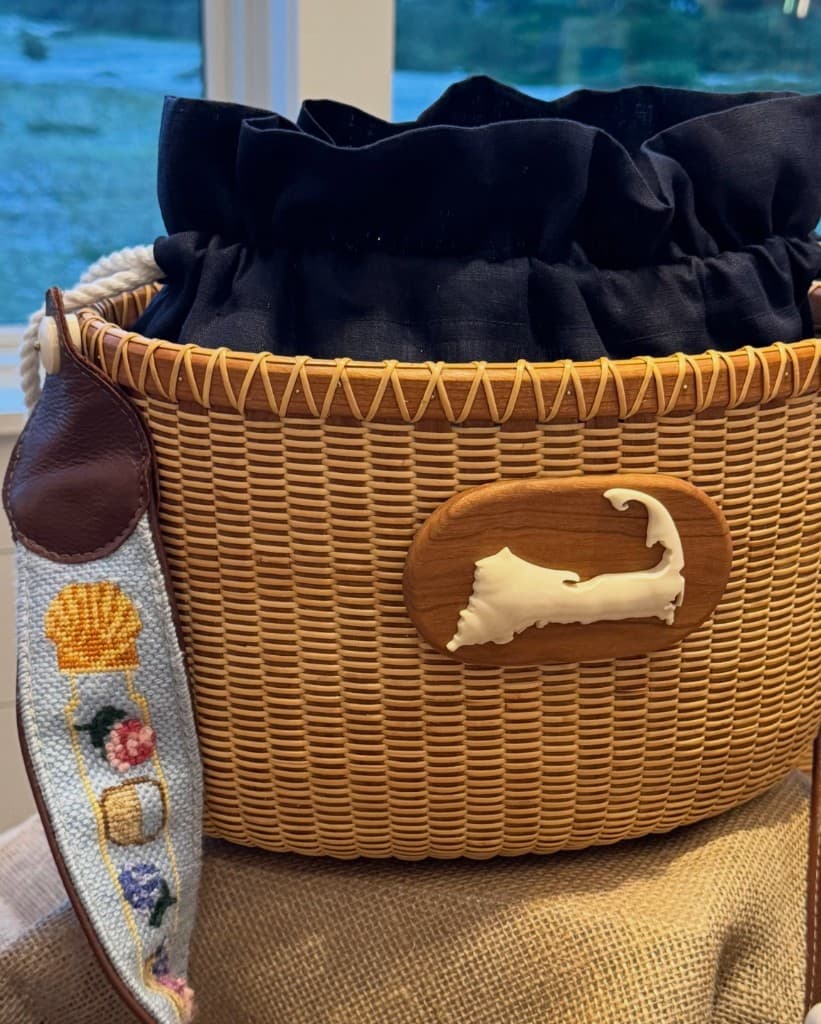 Custom Nantucket basket bag with needlepoint strap and ivory Cape Cod ornament