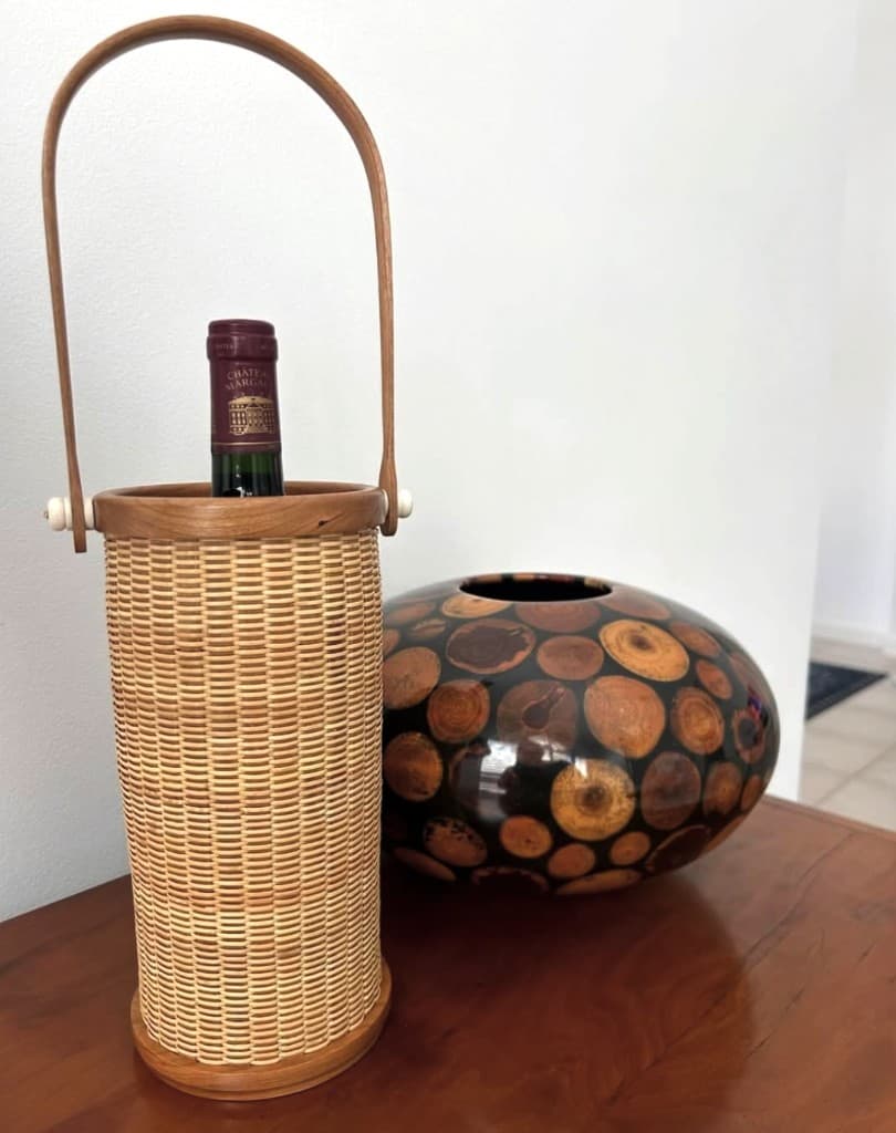 Handwoven Nantucket wine basket with hardwood handle and ivory knobs